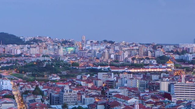 Panoramic aerial view on Rooftops of Porto's old town on a warm spring evening timelapse day to night transition from above, Porto, Portugal. Lights turning on on the streets with traffic