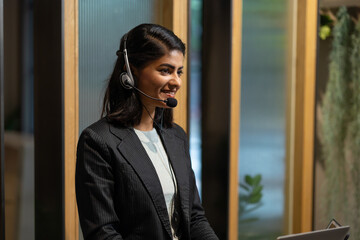 Asian indian woman call center - customer service. Attractive business Asian woman in suits and...