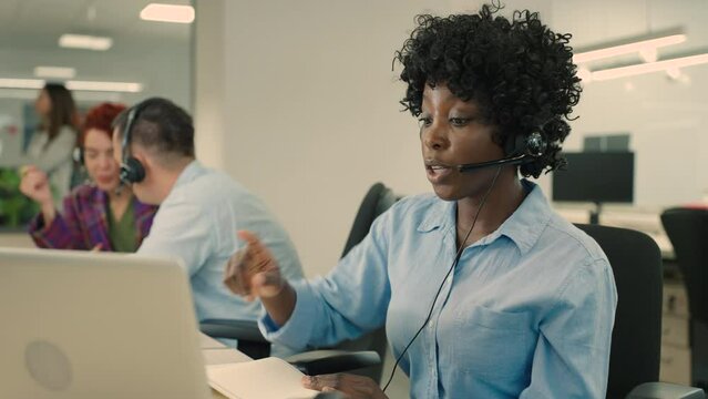 A multicultural technical support manager having a phone call with client.