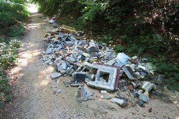Garbage deposit at the side of the road. - 775058949