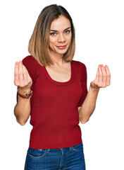 Young blonde girl wearing casual clothes doing money gesture with hands, asking for salary payment,...