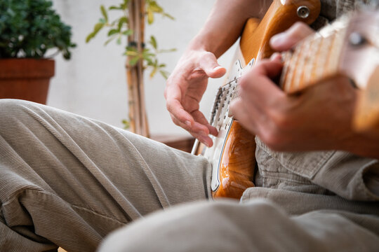 Side View Focus on Guitarist's Strumming Movement