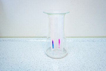 Dots marked with a felt-tip pen on filter paper move upwards in a special running fluid. This...