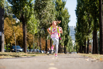 Photo portrait of ponytails cute small girl running shopping big sales dressed stylish garment elementary school student park