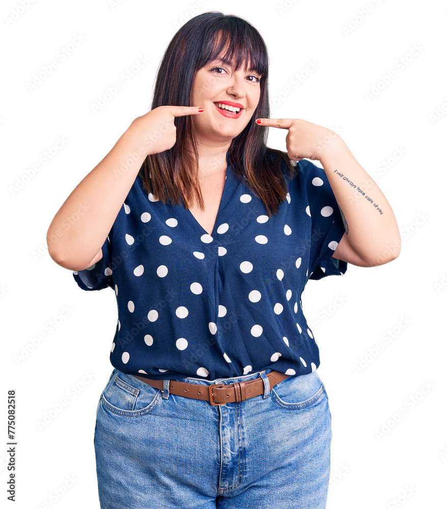 Sticker young plus size woman wearing casual clothes smiling cheerful showing and pointing with fingers teet