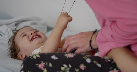 Woman in pink shirt change diapers to her baby boy