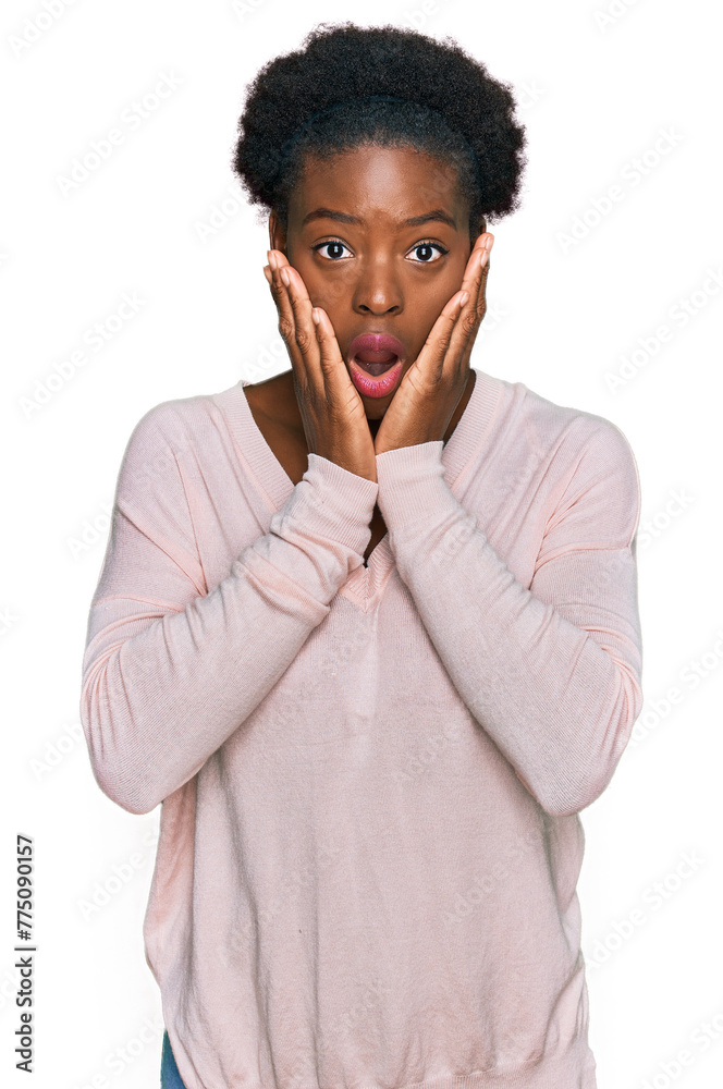 Canvas Prints Young african american girl wearing casual clothes afraid and shocked, surprise and amazed expression with hands on face