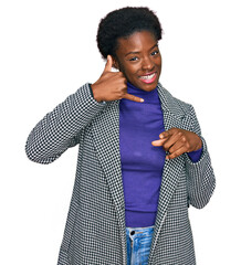 Young african american girl wearing casual clothes smiling doing talking on the telephone gesture...