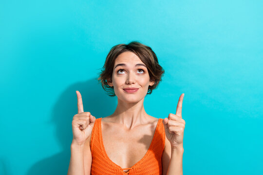 Photo of nice cheerful woman dressed knitwear singlet indicating look up at offer empty space isolated on turquoise color background