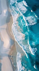 Aerial shot of a long stretch of pristine beach with turquoise waves crashing against the shore,...