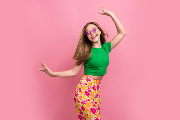 Photo portrait of pretty teenager girl dancing celebrate shopping promo wear trendy green outfit isolated on pink color background