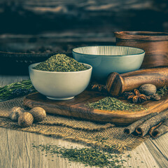 CORIANDER DRIED LEAF on wooden table background. Herbs, spices and dried food baking ingredient....