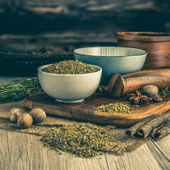 OREGANO DRIED on wooden table background. Herbs, spices and dried food baking ingredient. Mortar...