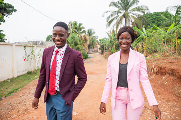 Two colleagues walking on their way to work, African business man and woman together smiling