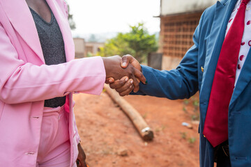 Handshake between a businessman and a businesswoman in Africa, equal opportunities