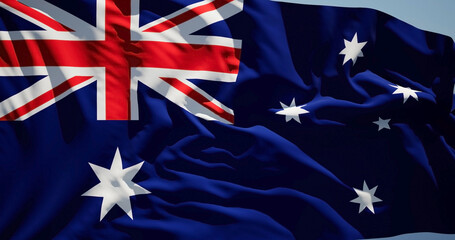 Close-up of the national flag of Australia flutters in the wind on a sunny day - 775109943