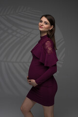 fashion model posing, portrait of a pregnant woman, pregnant woman in dress stands on a grey background close up, fashion pregnant model, pregnant woman stands on a grey background, studio shoot