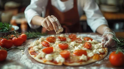 Foto op Canvas Female chef prepares pizza adding ingredients in Italian pizzeria. ,homemade pizza. © Viewvie