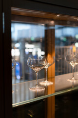 Champagne glasses on a self at a restaurant