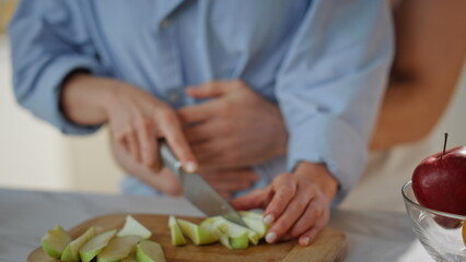 Affectionate couple preparing food at home kitchen closeup. Happy family morning