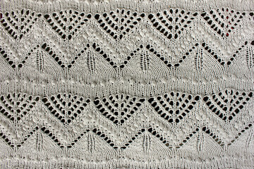 Textured white openwork close-up crochet. White patterned background