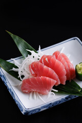 Tuna sashimi isolated in black background - 775120910