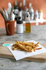 Homemade French fries on rustic wooden table - 775121500