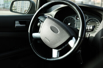 Black steering wheel and dashboard in car