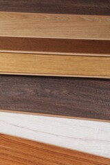 Different samples of wooden flooring as background, closeup