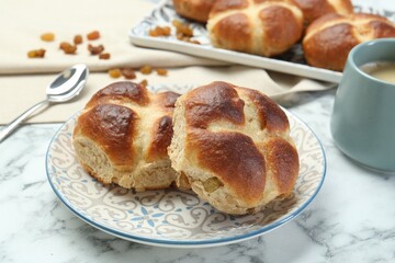 Hot cross buns served on white marble table