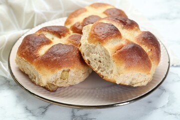 Hot cross buns on white marble table