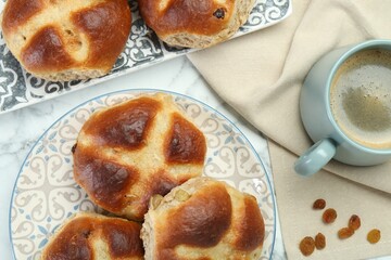 Hot cross buns served on white marble table, flat lay