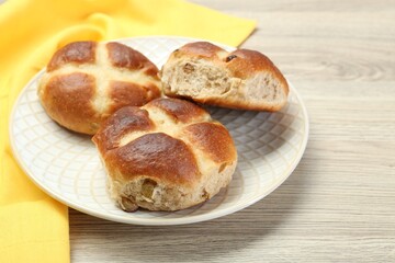 Hot cross buns on wooden table, closeup