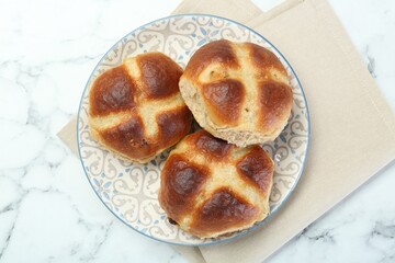 Hot cross buns on white marble table, top view