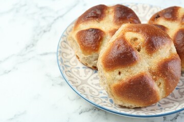Hot cross buns on white marble table, closeup. Space for text