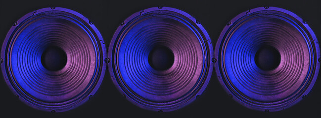 Close-up of speakers membrane on black background with colored lighting. - obrazy, fototapety, plakaty