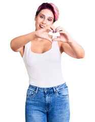 Young beautiful woman with pink hair wearing casual clothes smiling in love doing heart symbol shape with hands. romantic concept.