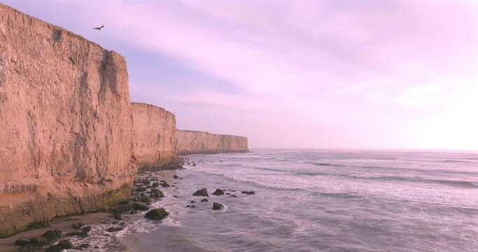 Aerial View of Stunning Cliffs Bathed by Waves in a Tranquil coast. Puerto Eten, Peru. 