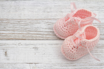 Pink baby booties on weathered wood - 775137309