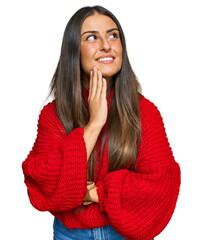 Beautiful hispanic woman wearing casual clothes with hand on chin thinking about question, pensive expression. smiling and thoughtful face. doubt concept.