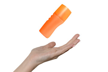 Hand of a young girl on a white background. Orange cosmetic cream.