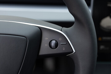 Steering wheel of electric vehicle, interior, cockpit, electric buttons. Electric car interior...