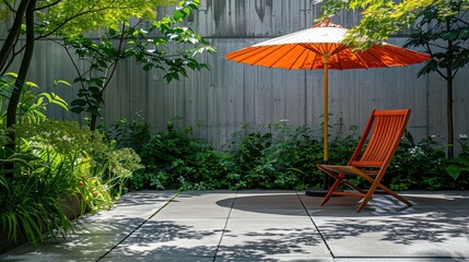 Wooden deck chair and red umbrella in the garden at summer day