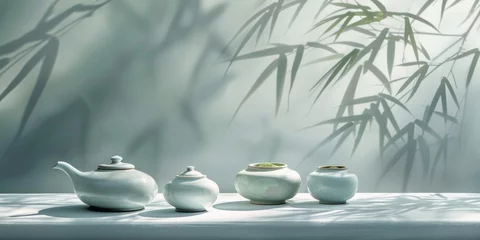 Foto op Plexiglas Private tea ceremony: white ceramic teaware, consisting of a teapot and cup, on a tray next to olive branches, against a dark background. © Marynkka_muis