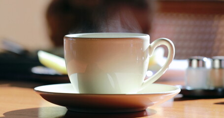 Warm cup of coffee with steam