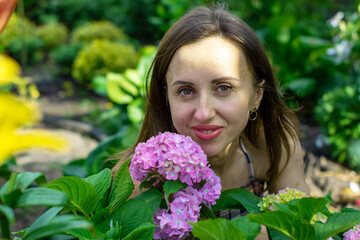 A beautiful woman in her own world of flowers.