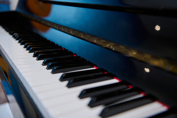 Macro shot of ebony and ivory keys of vintage black piano keys. White and black keyboard of...