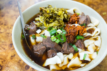 Spicy red soup beef noodle in a bowl - 775158116