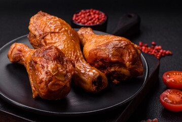 Delicious chicken legs baked on the grill with salt, spices and herbs