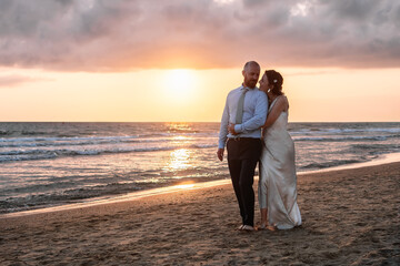 Couple Embracing on Beach at Sunset